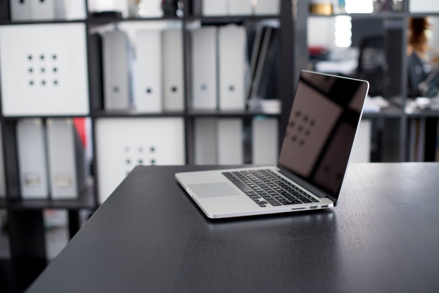 Laptop open on a desk in a modern office